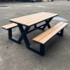 wooden outdoor dining table with matching benches